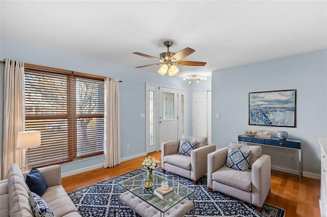 living room with wood-type flooring and ceiling fan