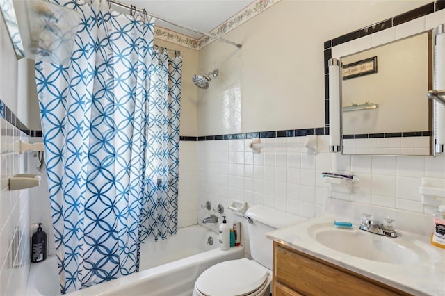 full bathroom with shower / tub combo with curtain, vanity, toilet, and tile walls