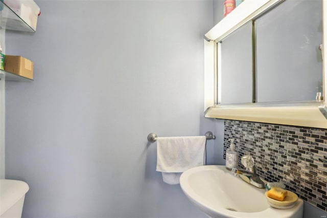 bathroom with sink and backsplash