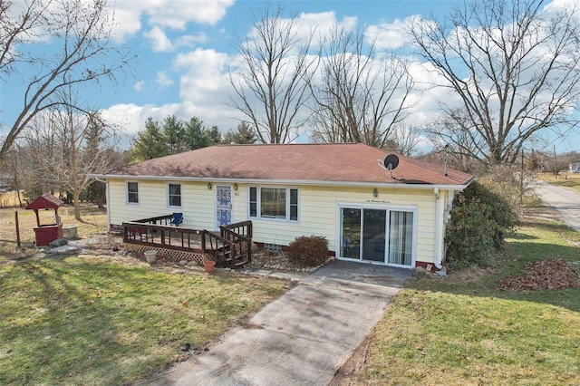 back of property featuring a yard and a deck