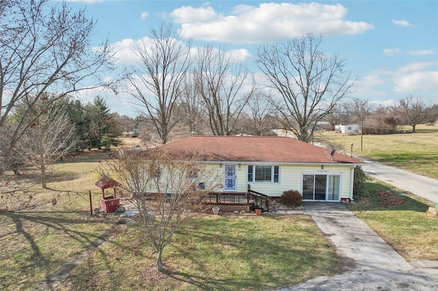 view of front of house with a wooden deck and a front lawn