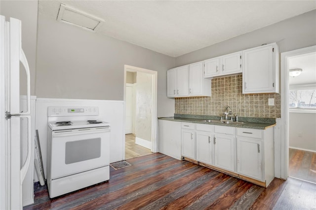kitchen featuring sink, white cabinets, decorative backsplash, dark wood-type flooring, and white appliances