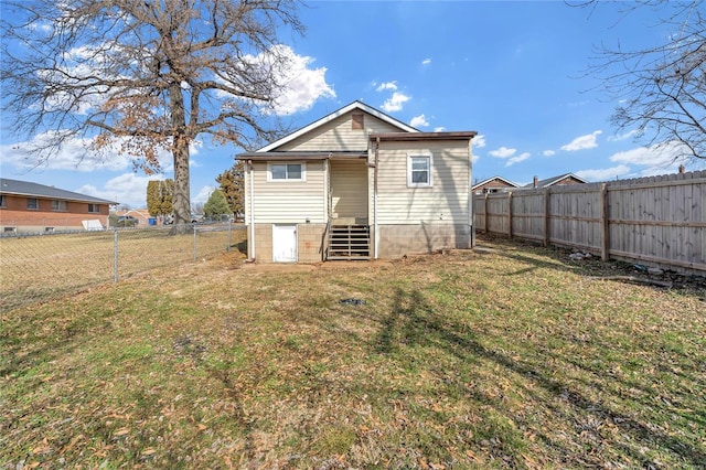 rear view of property with a lawn