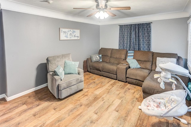 living room featuring crown molding, ceiling fan, and hardwood / wood-style flooring