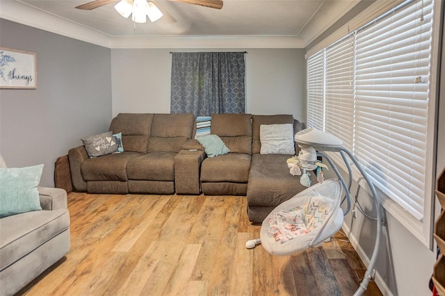 living room with ornamental molding, hardwood / wood-style floors, and ceiling fan