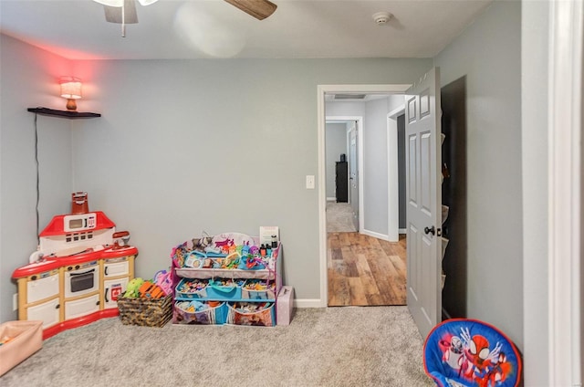 rec room with light carpet and ceiling fan