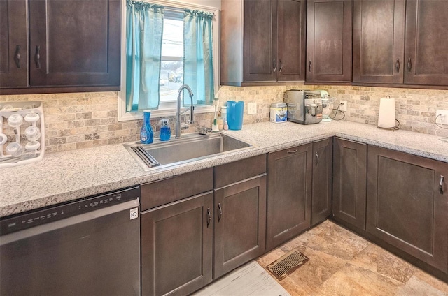 kitchen with dark brown cabinetry, sink, stainless steel dishwasher, and light stone countertops