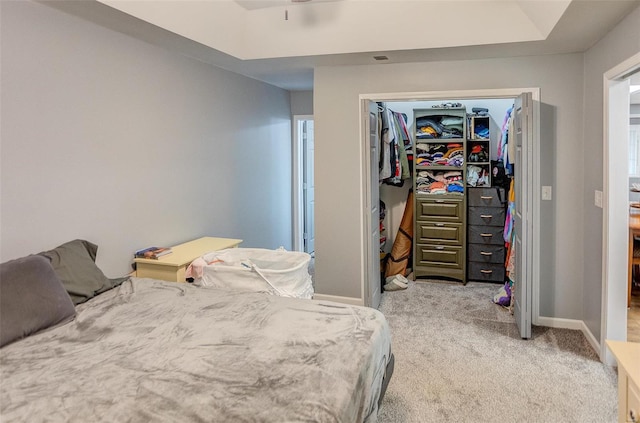 bedroom featuring light carpet and a closet