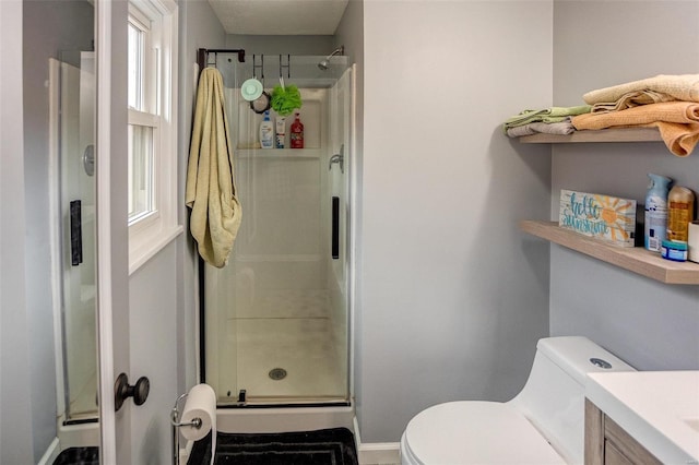 bathroom with vanity, toilet, and walk in shower