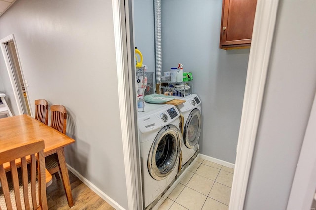 laundry room with light tile patterned floors and washing machine and dryer