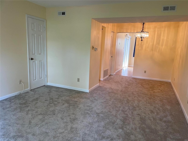 unfurnished room with carpet flooring, baseboards, and visible vents