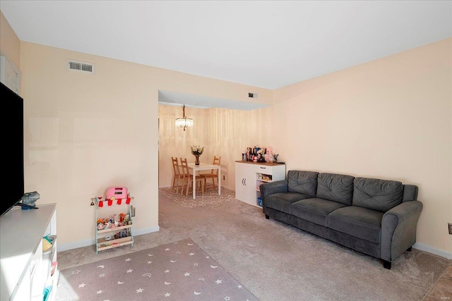 living room featuring an inviting chandelier, carpet flooring, baseboards, and visible vents