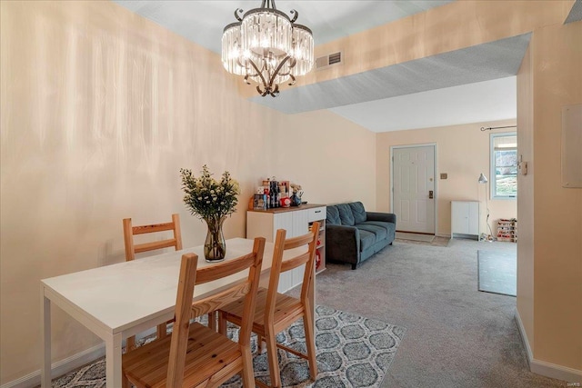 carpeted dining space featuring an inviting chandelier, baseboards, and visible vents