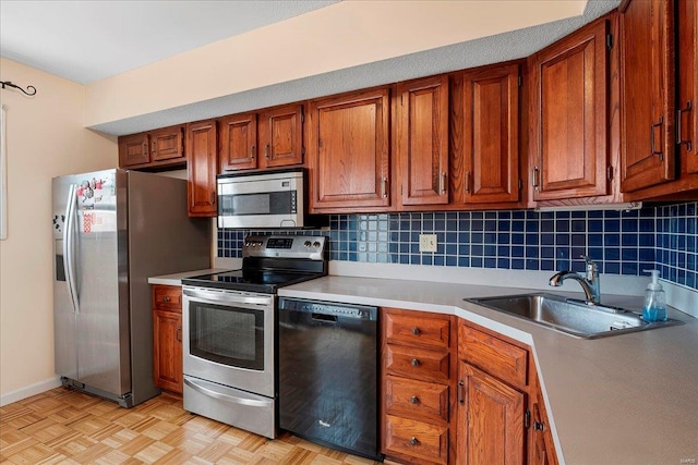 kitchen featuring a sink, stainless steel appliances, backsplash, and brown cabinetry