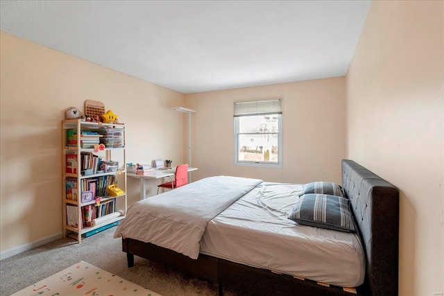 bedroom featuring baseboards and carpet