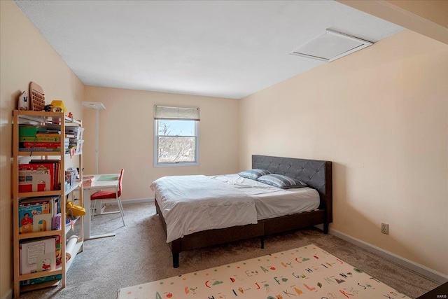 carpeted bedroom with attic access and baseboards