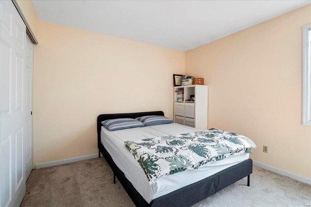 carpeted bedroom with baseboards