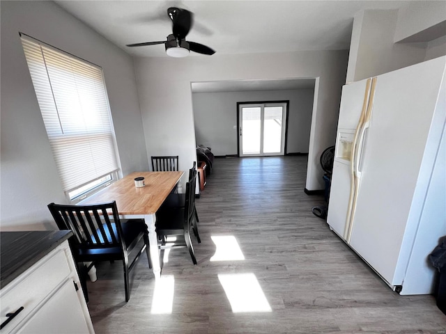 dining space featuring ceiling fan and light wood-style floors