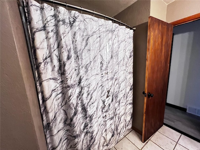 bathroom with tile patterned floors