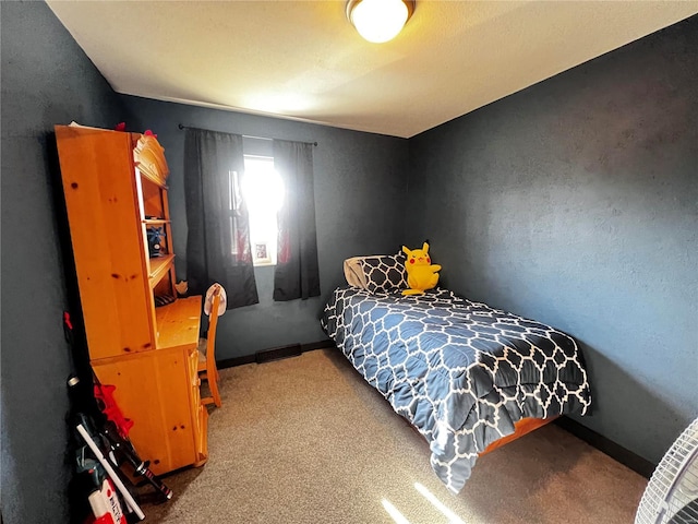 bedroom with carpet floors and baseboards