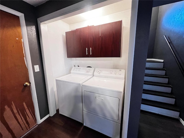 clothes washing area featuring cabinets and washer and dryer