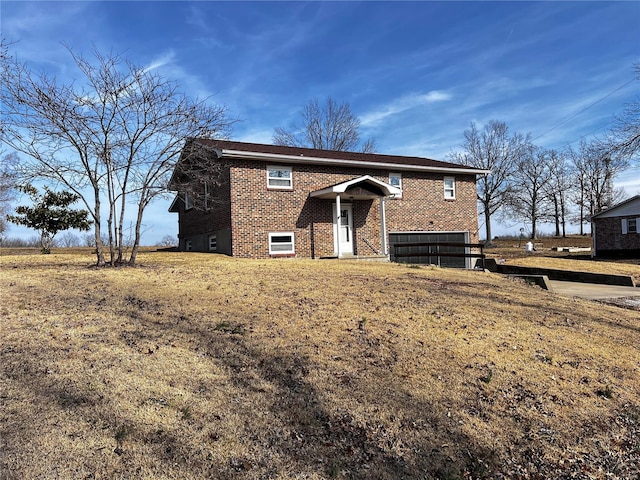 raised ranch with a front yard