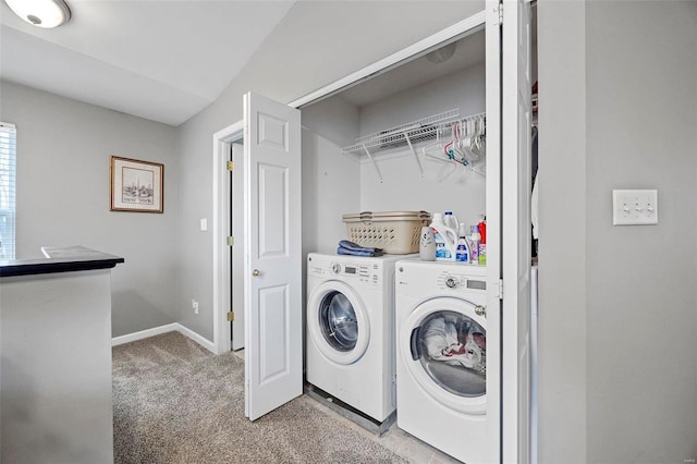 washroom with washer and clothes dryer and light carpet