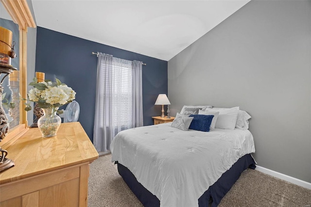 carpeted bedroom featuring lofted ceiling