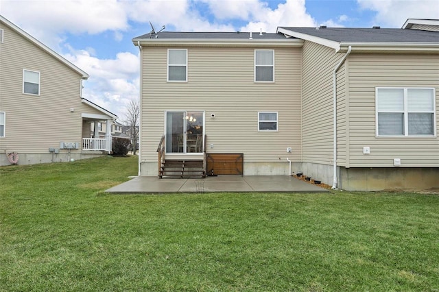 rear view of property featuring a patio and a lawn