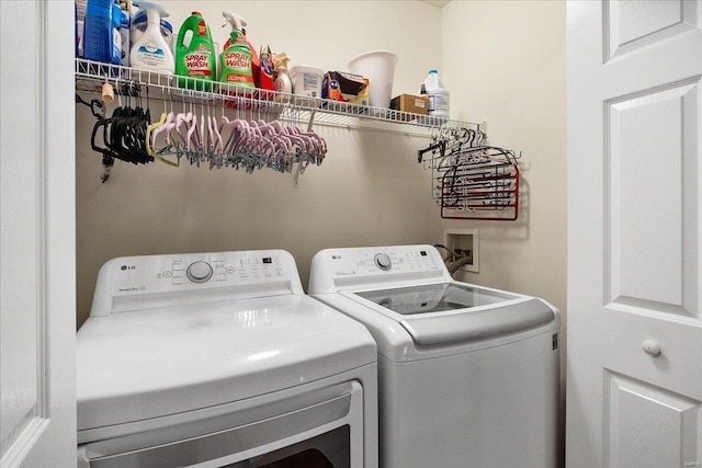 clothes washing area featuring separate washer and dryer