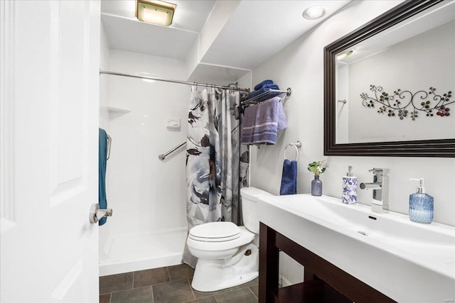 bathroom featuring toilet, vanity, and a shower with curtain