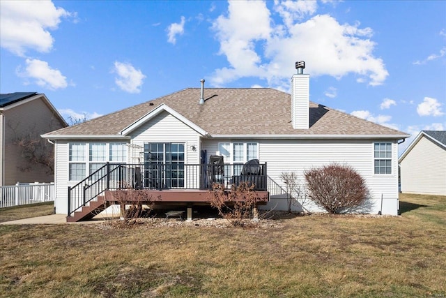 back of property with a wooden deck and a lawn