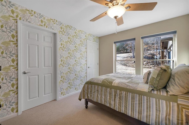 carpeted bedroom featuring baseboards, ceiling fan, and wallpapered walls