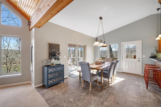 dining room featuring high vaulted ceiling, a wealth of natural light, tile patterned flooring, and baseboards