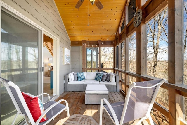 sunroom featuring lofted ceiling, wood ceiling, and a ceiling fan