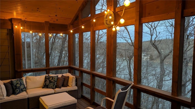 unfurnished sunroom featuring wood ceiling and vaulted ceiling