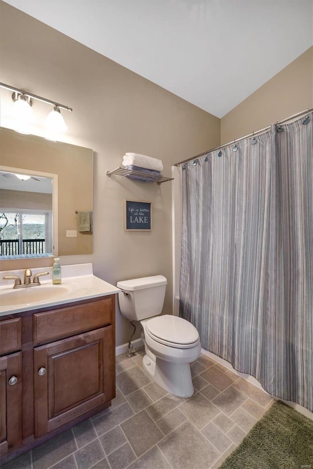 full bathroom with lofted ceiling, vanity, and toilet