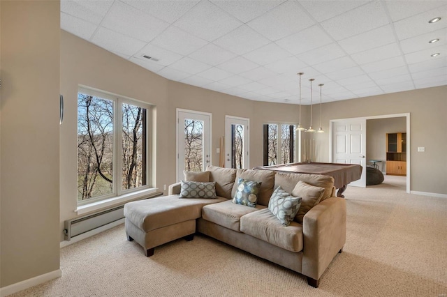 living area with baseboards, a drop ceiling, visible vents, and light colored carpet