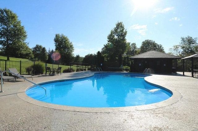 view of swimming pool featuring fence, a fenced in pool, and a patio