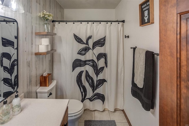 bathroom featuring vanity, tile patterned floors, and toilet