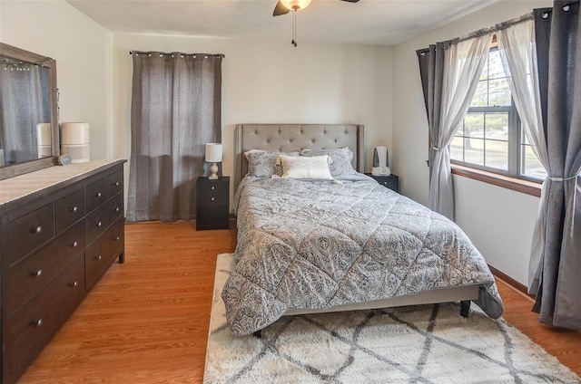 bedroom with ceiling fan and light hardwood / wood-style floors