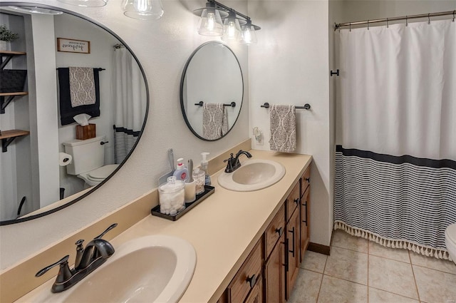 bathroom featuring vanity, tile patterned floors, and toilet