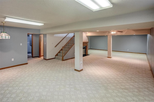 basement featuring a textured ceiling and carpet