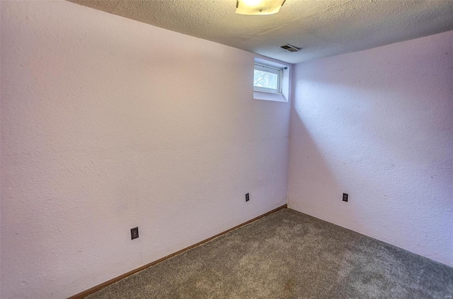 empty room featuring carpet flooring and a textured ceiling