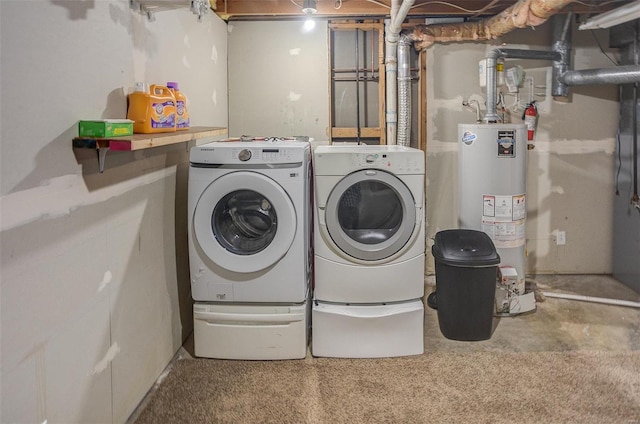 laundry room with separate washer and dryer and water heater