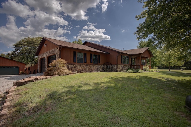 single story home featuring a garage, a front yard, and covered porch