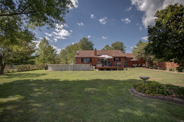 view of yard with a swimming pool side deck