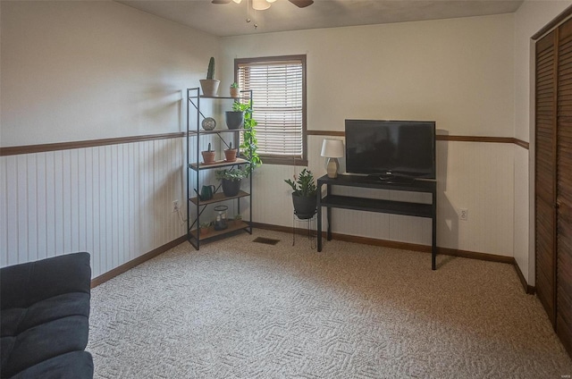 interior space featuring carpet and ceiling fan