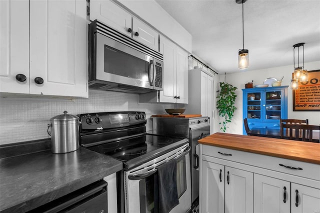 kitchen with butcher block counters, tasteful backsplash, pendant lighting, stainless steel appliances, and white cabinets