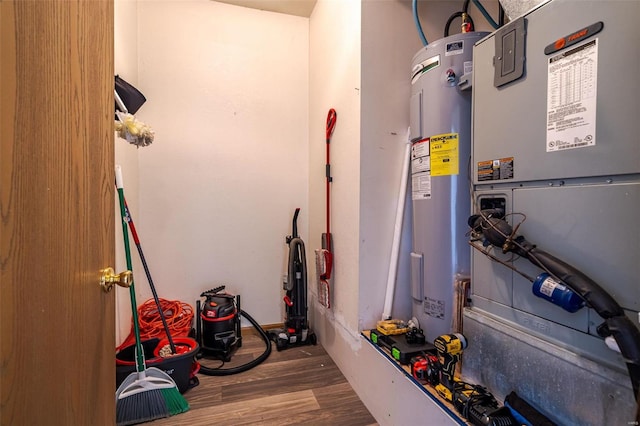 utility room featuring electric water heater and heating unit